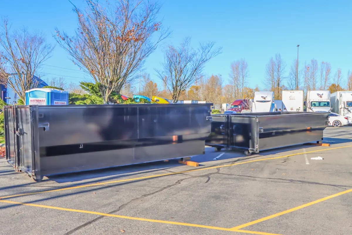 Professional dumpster rental service with roll-off container on residential driveway in Sugar Hill